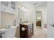 Bathroom featuring granite countertop vanity and a decorative shelf and mirror at 2418 Falcon Ln, Palm Harbor, FL 34683