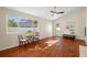 Cozy living room featuring a ceiling fan, hardwood floors, and a dining nook at 2418 Falcon Ln, Palm Harbor, FL 34683