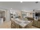 Light and airy dining area with a large table and adjacent kitchen at 2620 Renatta Dr, Belleair Bluffs, FL 33770