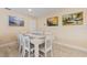 Bright dining room with white table and six chairs at 2620 Renatta Dr, Belleair Bluffs, FL 33770