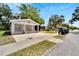 Gray bungalow with a covered porch and landscaping; street view at 2622 E Genesee St, Tampa, FL 33610