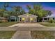 Charming bungalow at dusk, featuring a covered porch and updated exterior at 2622 E Genesee St, Tampa, FL 33610