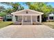 Charming bungalow with a covered porch and well-manicured front yard at 2622 E Genesee St, Tampa, FL 33610