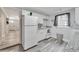 Modern white kitchen with stainless steel appliances and granite counters at 2622 E Genesee St, Tampa, FL 33610