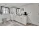 White kitchen cabinets, granite countertops, and laundry area at 2622 E Genesee St, Tampa, FL 33610