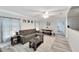 Bright living room features L-shaped sofa, dining area, and wood-look floors at 2622 E Genesee St, Tampa, FL 33610