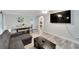 Open living space with L-shaped sofa, dining area, and large TV at 2622 E Genesee St, Tampa, FL 33610