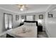 Main bedroom with king-size bed, ceiling fan, and gray accents at 2622 E Genesee St, Tampa, FL 33610