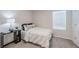 Simple bedroom with double bed, nightstand, and window at 28818 Orange Berry Dr, Wesley Chapel, FL 33543