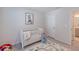 Bedroom features a crib, playmat, and a view into the bathroom at 28818 Orange Berry Dr, Wesley Chapel, FL 33543