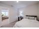 Bright bedroom with double bed, nightstand, and view of living room at 28818 Orange Berry Dr, Wesley Chapel, FL 33543