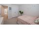Charming bedroom featuring a bed, decorative accents, and access to hallway at 28818 Orange Berry Dr, Wesley Chapel, FL 33543