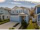 Two-story house with gray and blue siding, two-car garage, and landscaping at 28818 Orange Berry Dr, Wesley Chapel, FL 33543