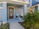 Front porch with rocking chairs and landscaping at 28818 Orange Berry Dr, Wesley Chapel, FL 33543
