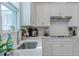 Kitchen sink and countertop with white cabinets at 28818 Orange Berry Dr, Wesley Chapel, FL 33543