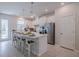 Modern kitchen with white cabinets, island, and stainless steel appliances at 28818 Orange Berry Dr, Wesley Chapel, FL 33543