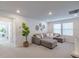 Spacious loft with gray sectional sofa and large windows at 28818 Orange Berry Dr, Wesley Chapel, FL 33543