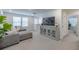 Comfortable loft area with sectional sofa and media console at 28818 Orange Berry Dr, Wesley Chapel, FL 33543