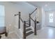 Modern staircase with dark wood and white railings at 28818 Orange Berry Dr, Wesley Chapel, FL 33543
