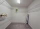 Spacious walk-in closet with wire shelving and mirrored doors at 28818 Orange Berry Dr, Wesley Chapel, FL 33543