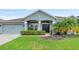 One-story home with gray exterior, two-car garage, and landscaped yard at 31055 Edendale Dr, Wesley Chapel, FL 33543