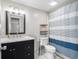 Updated bathroom with granite vanity, new fixtures, and striped shower curtain at 3612 Phillips St, Tampa, FL 33619