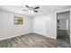 Bright bedroom featuring wood-look flooring and ceiling fan at 3612 Phillips St, Tampa, FL 33619