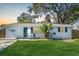 Charming light blue house with a well-manicured lawn at 3612 Phillips St, Tampa, FL 33619