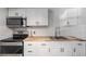 Modern kitchen with white cabinets and stainless steel appliances at 3612 Phillips St, Tampa, FL 33619