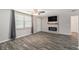 Living room with hardwood floors, fireplace, and large TV at 3612 Phillips St, Tampa, FL 33619