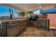 Outdoor kitchen with a built-in refrigerator and grill at 366 La Hacienda Dr, Indian Rocks Beach, FL 33785