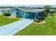 Aerial view of a light blue manufactured home with a carport at 37622 New Horizons Blvd, Zephyrhills, FL 33541