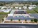 Aerial view of community clubhouse, pool, shuffleboard courts, and parking at 37622 New Horizons Blvd, Zephyrhills, FL 33541