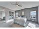Bedroom with ceiling fan, mirrored closet and grey accent wall at 37622 New Horizons Blvd, Zephyrhills, FL 33541