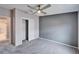 Spacious bedroom with ceiling fan, mirrored closet doors, and grey accent wall at 37622 New Horizons Blvd, Zephyrhills, FL 33541