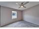 Bright bedroom featuring a ceiling fan and a window offering natural light at 37622 New Horizons Blvd, Zephyrhills, FL 33541