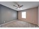 Spacious bedroom with grey and pink walls and ceiling fan at 37622 New Horizons Blvd, Zephyrhills, FL 33541