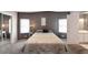 Bedroom with ceiling fan, mirrored closet, and grey accent wall at 37622 New Horizons Blvd, Zephyrhills, FL 33541