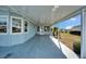 Covered patio with concrete flooring adjacent to home at 37622 New Horizons Blvd, Zephyrhills, FL 33541