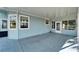 Large covered patio with concrete flooring at 37622 New Horizons Blvd, Zephyrhills, FL 33541