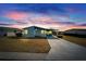 Single-story home at dusk with carport and yard at 37622 New Horizons Blvd, Zephyrhills, FL 33541
