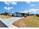 Single-story home with carport and landscaped yard at 37622 New Horizons Blvd, Zephyrhills, FL 33541
