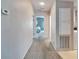 Hallway with carpet flooring and doors to bedrooms at 37622 New Horizons Blvd, Zephyrhills, FL 33541