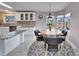 Modern kitchen with white cabinets, granite countertops, and stainless steel appliances at 37622 New Horizons Blvd, Zephyrhills, FL 33541