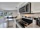 Stainless steel appliances and granite countertops in kitchen at 37622 New Horizons Blvd, Zephyrhills, FL 33541
