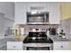 Kitchen with stainless steel range and microwave at 37622 New Horizons Blvd, Zephyrhills, FL 33541