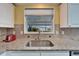 Stainless steel sink and granite countertops in the kitchen at 37622 New Horizons Blvd, Zephyrhills, FL 33541