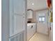 Bright laundry room, washer, dryer, cabinets, and exterior access at 37622 New Horizons Blvd, Zephyrhills, FL 33541