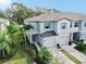 Two-story townhome with light blue exterior and palm trees at 3818 Cat Mint St, Tampa, FL 33619
