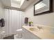 Bright bathroom featuring a framed mirror, shower with curtain and neutral color palette at 4725 Christa Ct # 331, Tampa, FL 33614